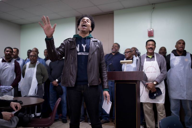 Otis Byrd Jr. leads Antioch Baptist Church North Male Chorus members as they sing a hymn during an early Thanksgiving meal at the Salvation Army on Nov. 15, 2018, in Atlanta.  BRANDEN CAMP/SPECIAL