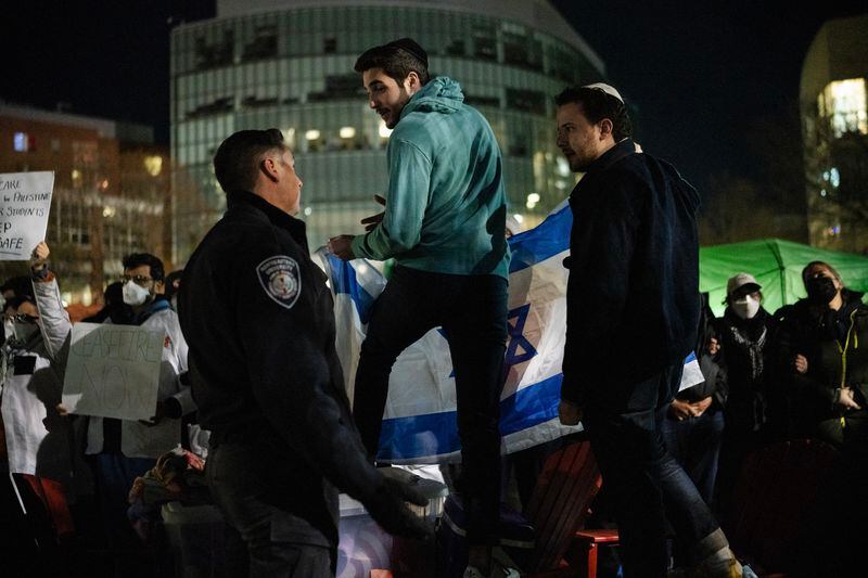 
                        A police officer appeals to Jewish counter-protesters to disengage with pro-Palestinian students at their protest encampment on the campus at Northeastern University in Boston, Mass., on Friday, April 26, 2024. At the encampment at Northeastern University, police officers detained about 100 people and took several tents down on Saturday. (Sophie Park/The New York Times)
                      