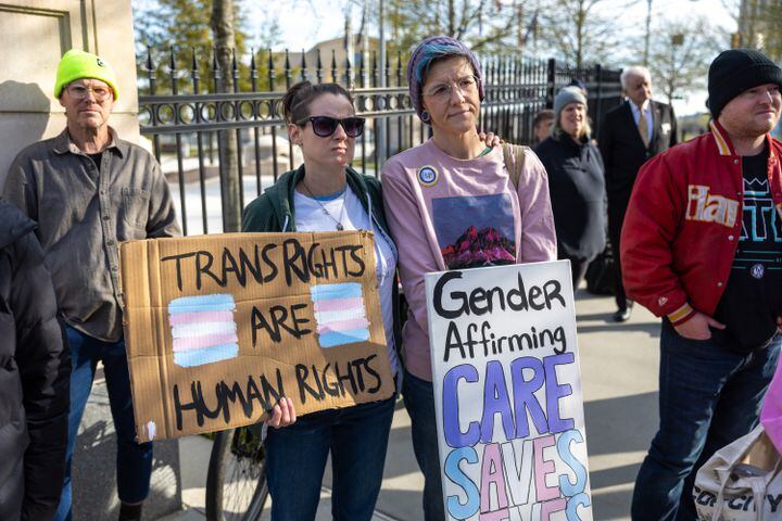 Pam Miller and Maha Taylor attend a rally against SB 140 outside the Capitol in Atlanta on Monday, March 20, 2023. SB 140 would prevent medical professionals from giving transgender children certain hormones or surgical treatment. (Arvin Temkar / arvin.temkar@ajc.com)