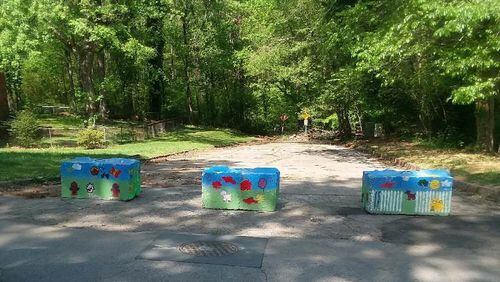 Colorful barriers to keep illegal dumpers away from isolated property are just one way DeKalb County is trying to stop blight.