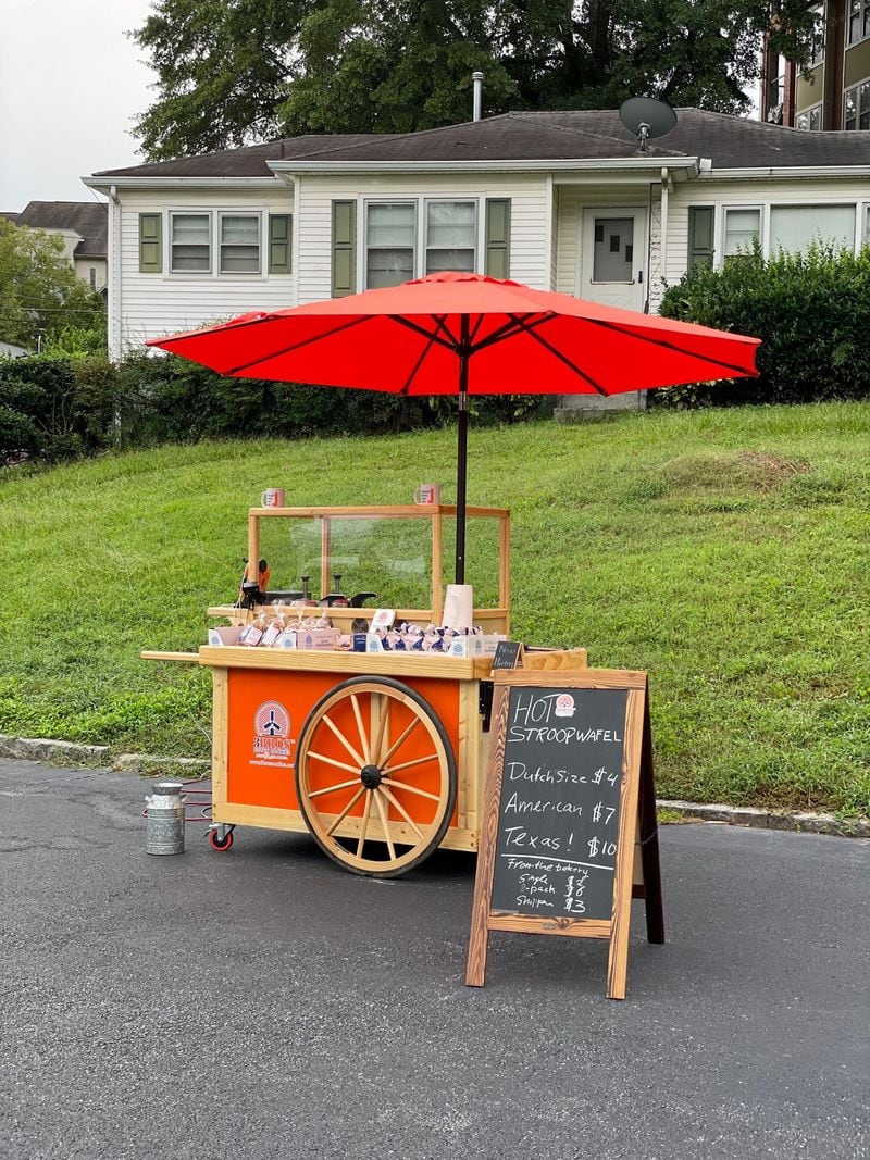 The Vliegens travel to farmers markets and events with a bright orange, wheeled cart fitted with a stroopwafel iron and syrup dispenser. Courtesy of 3Bros Cookies