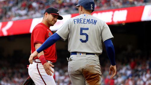 Braves third baseman Austin Riley, left, greets Los Angeles Dodgers first baseman Freddie Freeman during the first inning of a game at Truist Park on Friday, June 24, 2022, in Atlanta. (Jason Getz / Jason.Getz@ajc.com)
