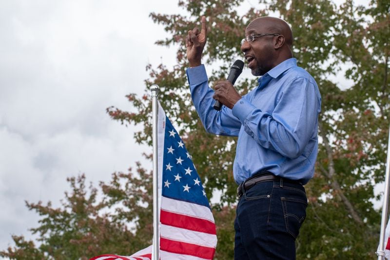 Democratic senatorial candidate Raphael Warnock addresses a crowd at a Gwinnett County rally in October. Throughout the tight and tense campaign, his opponent, Sen. Kelly Loeffler, has repeatedly made issue out of his mix of theology and political activism.