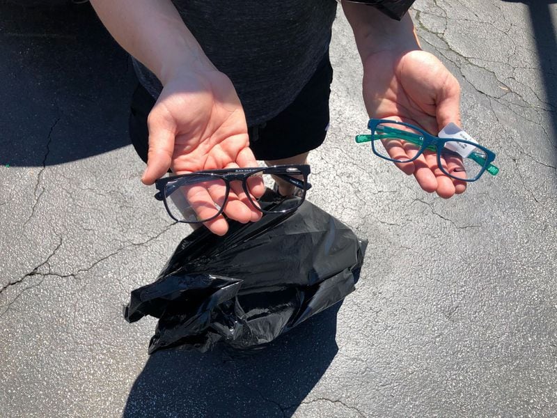 Claire Maki shows off glasses she found on the ground outside Pearle Vision in the Across Lenox shopping plaza. MARLON A. WALKER/STAFF