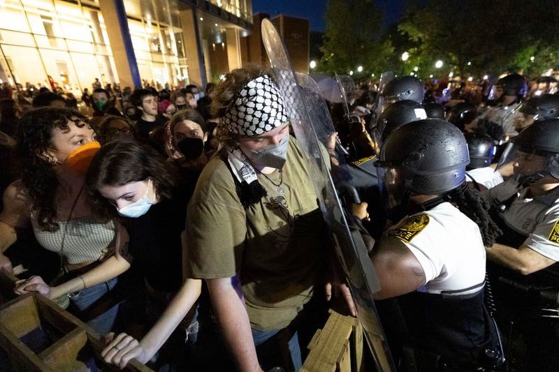 Demonstrators and law enforcement officers clash during a pro-Palestinian rally at Virginia Commonwealth University, Monday, April 29, 2024, in Richmond, Va. (Mike Kropf/Richmond Times-Dispatch via AP)