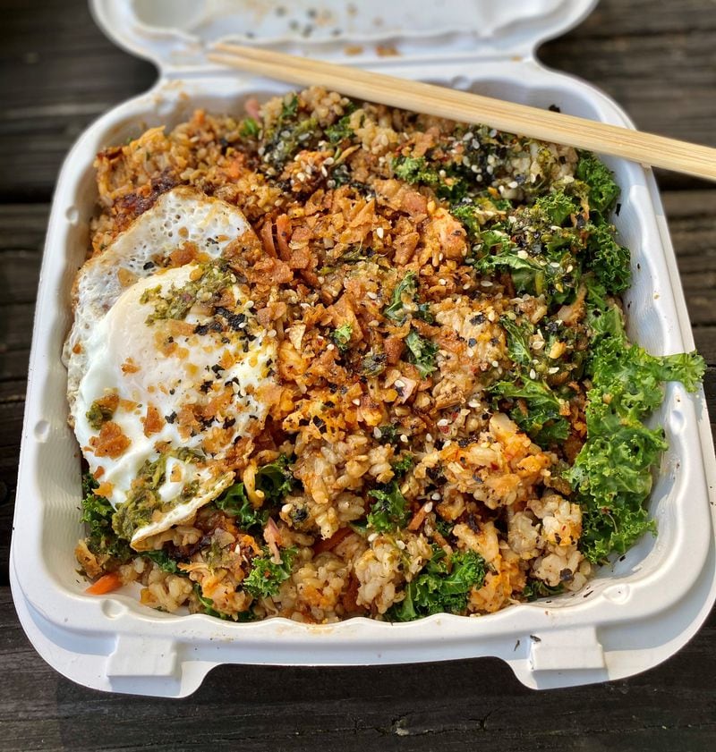 Mushi Ni’s chop suey rice box comes with a choice of grain and two proteins. It’s shown here with garlic fried rice, lobster hash and Manila chicken adobo, plus a fried egg. Wendell Brock for The Atlanta Journal-Constitution
