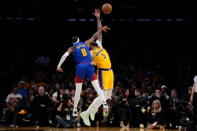 Denver Nuggets forward Peyton Watson (8) fouls Los Angeles Lakers forward Anthony Davis (3) during the first half of Game 3 of an NBA basketball first-round playoff series in Los Angeles, Thursday, April 25, 2024. (AP Photo/Ashley Landis)