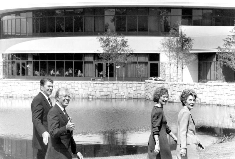 Jimmy Carter gives a thumbs up sign as he and Rosalynn give a tour of the Carter Center to Ronald and Nancy Reagan. Circa 1986. Credit / Joey Ivansco