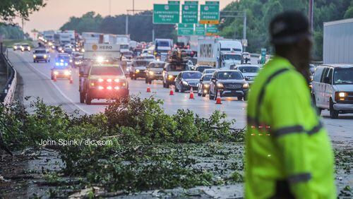 One right lane and the exit ramp to Church Street were blocked on I-285 South in DeKalb County on Thursday morning after a tree crashed through a barrier wall and landed on the interstate, hitting three vehicles on its way down.