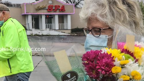 Dan and Charlotte Hayes of Sandy Springs took flowers to the Gold Spa on Wednesday, less than 24 hours after the shooting on Piedmont Road.