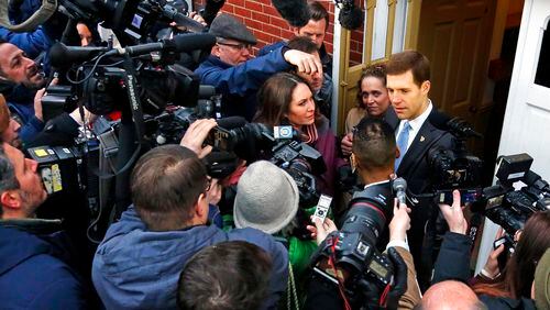 Conor Lamb, the Democratic candidate for the special election in Pennsylvania's 18th Congressional District, right, is surrounded by media after voting in Mount Lebanon, Pa., Tuesday, March 13, 2018. Lamb is running against Republican Rick Saccone. (AP Photo/Gene J. Puskar)