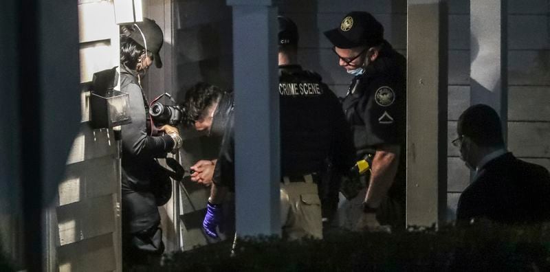 Investigators remove ballistics found on the house exterior. Two people were killed and two others were injured on July 24, 2020, when gunfire erupted outside a house party in northwest Atlanta'ss Vine City neighborhood, authorities said. (JOHN SPINK / JSPINK@AJC.COM)