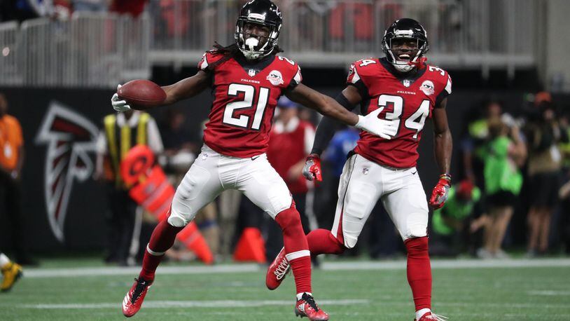 Atlanta Falcons cornerback Desmond Trufant (21) celebrates his interception with cornerback Brian Poole (34) in the second quarter of their game against the Green Bay Packers at Mercedes-Benz Stadium.