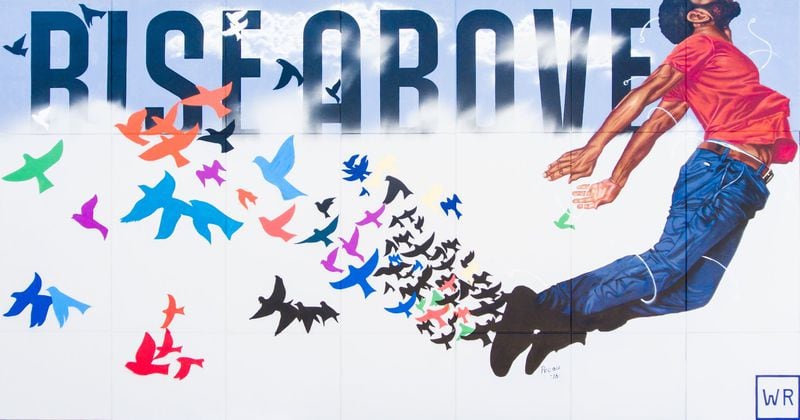 Fahamu Pecou painted “Rise Above” on the side of the King Memorial MARTA station, as a part of the En Route program, an effort by non-profit arts group WonderRoot to give voice to the community. CONTRIBUTED: WONDERROOT