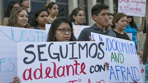 Several people gathered on the plaza of the J.J.Pickle Federal Building on Tuesday afternoon to protest President Donald Trump’s decision to rescind the Obama-era Deferred Action for Childhood Arrivals program, also known as DACA. Edilsa Lopez, left, a graduate of the University of Texas at Austin, and Jose Garibay, a current St. Edward’s University student, are both DACA status recipients who participated in a protest against the president’s action.
