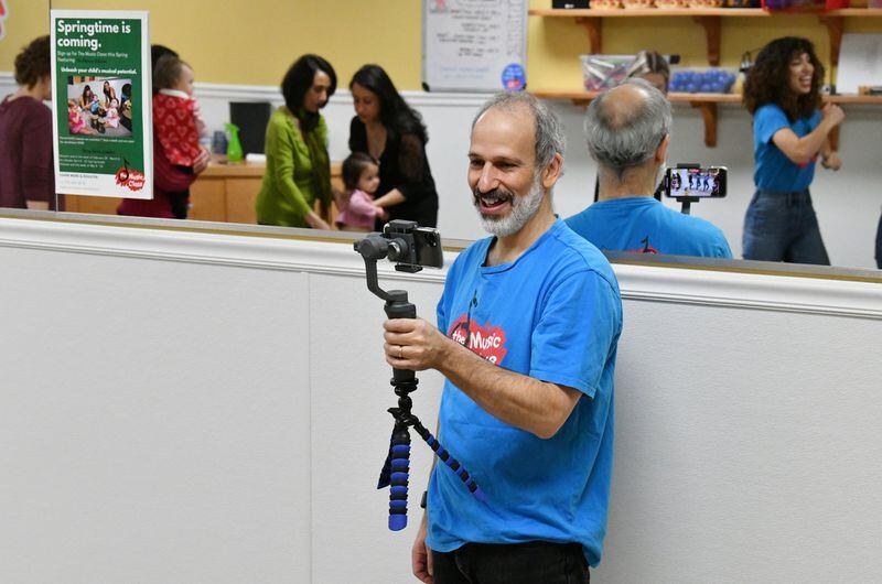 Rob Sayer, founder and CEO of The Music Class, holds a smartphone to film a class, which will broadcast in China for families who stuck at home during the coronavirus outbreak. The Music Class is an international music education program. (Hyosub Shin / Hyosub.Shin@ajc.com)