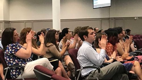 Parents and students applaud one of several speakers who complained about some sex education lessons taught by a group during the June 15, 2017 Gwinnett County school board meeting. ERIC STIRGUS / ESTIRGUS@AJC.COM