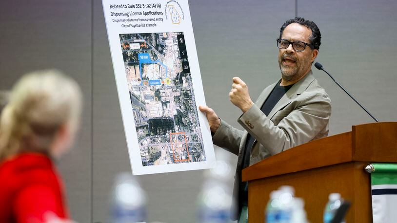 Michael Mumper of Georgians for Responsible Marijuana Policy, shows a map of the city of Fayetteville to the Georgia Access to Medical Cannabis Commission during a hearing Wednesday in Gainesville. Mumper asked for rules that would prevent sales within 3,000 feet of churches or schools. Jason Getz / Jason.Getz@ajc.com)