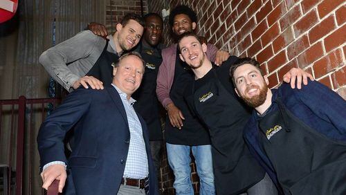 Hawks coach Mike Budenholzer with players Kris Humphries, Taurean Prince, DeAndre Bembry, Mike Muscala and Ryan Kelly at a recent dinner to raise money for the Atlanta Community Food Bank. Photo provided.