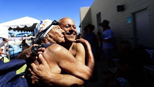 Master swimmers Maurine Kornfeld, 97, left, greets her pal Errol Graham, right, with a big hug during the USMS Spring National Championship at Kino Aquatic Center in Mesa, Arizona, in April. Maurine routinely swims at several pools in the Los Angeles area and she knows Errol from the West Hollywood Aquatics pool. Francine Orr/Los Angeles Times/TNS