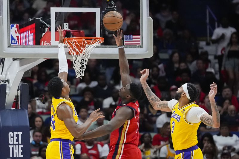 New Orleans Pelicans forward Zion Williamson (1) goes to the basket between Los Angeles Lakers forward Rui Hachimura and forward Anthony Davis (3) in the first half of an NBA basketball play-in tournament game Tuesday, April 16, 2024, in New Orleans. (AP Photo/Gerald Herbert)