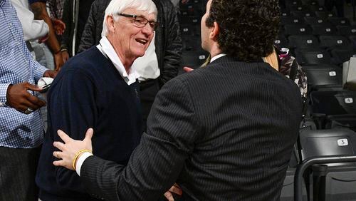 Past Georgia Tech head coach Bobby Cremins, left, and present head coach Josh Pastner celebrate after an NCAA college basketball game against Syracuse , Sunday, Feb. 19, 2017, in Atlanta. Tech won 71-65. (John Amis)