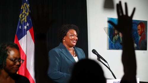 A supporter waves as Democratic nominee for Governor Stacey Abrams concludes her economic address outlining her vision for Georgia’s economy earlier this month in Atlanta. In recent years, Abrams has amassed a lucrative portfolio of business deals and investments that could present potential conflicts if she is elected. (Curtis Compton / Curtis Compton@ajc.com)