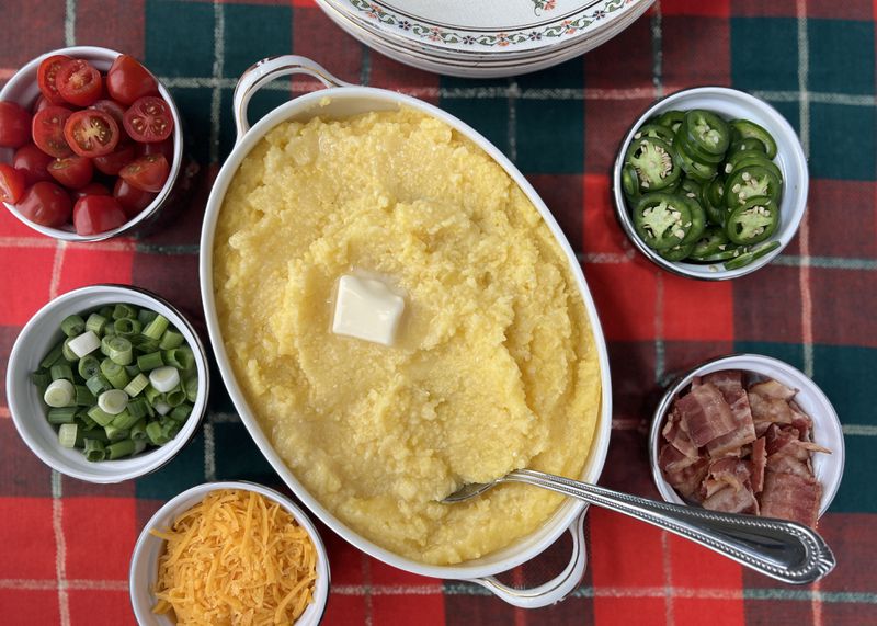 Stone ground grits cooked overnight in the slow cooker becomes a customizable grits bar when served with bacon, green onions, jalapeno, grape tomatoes and shredded cheese. 
(Virginia Willis for The Atlanta Journal-Constitution)