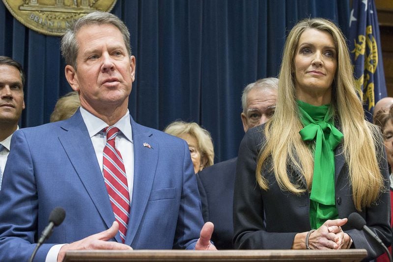 Newly appointed U.S. Sen. Kelly Loeffler listens as Georgia Gov. Brian Kemp speaks during a press conference in his office at the Georgia State Capitol Building on December 4, 2019. Kemp appointed Loeffler to the U.S. Senate to take the place of Sen. Johnny Isakson, who resigned for health reasons. (ALYSSA POINTER/Alyssa.Pointer@AJC.com)