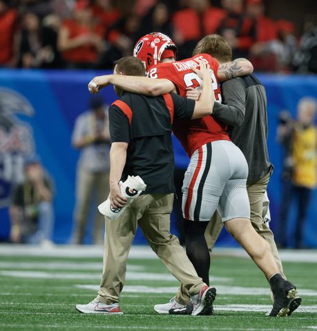 Georgia Bulldogs linebacker Chaz Chambliss (32) is helped off the field during the second quarter of the College Football Playoff Semifinal between the Georgia Bulldogs and the Ohio State Buckeyes at the Chick-fil-A Peach Bowl In Atlanta on Saturday, Dec. 31, 2022. (Jason Getz / Jason.Getz@ajc.com)