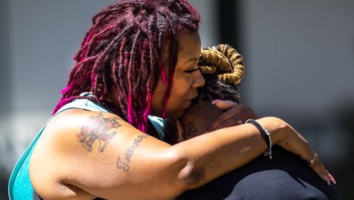Angela Cooper embraces Jamese Nathan, who works at the Northside Hospital Midtown medical office building where five people were shot on Wednesday, May 3, 2023. One person died. (Arvin Temkar / arvin.temkar@ajc.com)