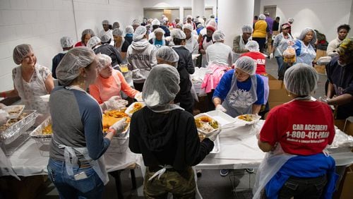Over 1,540 volunteers work on boxing up meals during the Hosea Helps 2019 Thanksgiving Festival at the Georgia World Congress Center.  STEVE SCHAEFER / SPECIAL TO THE AJC