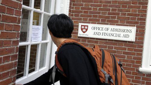 A student enters Admissions Building at Harvard University