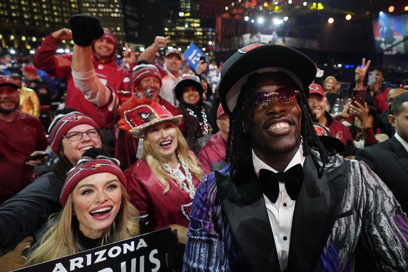 Missouri defensive lineman Darius Robinson poses with fans after being chosen by the Arizona Cardinals with the 27th overall pick during the first round of the NFL football draft, Thursday, April 25, 2024, in Detroit. (AP Photo/Paul Sancya)