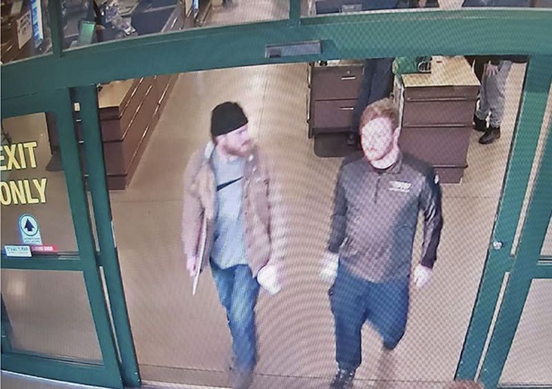 In this file image from a Jan. 1 surveillance video released by the U.S. Attorney's Office in Maryland, Brian Mark Lemley Jr., right, and Patrik Mathews leave a store in Delaware where they purchased ammunition and paper shooting targets. The pair, along with William Garfield Bilbrough IV, were arrested in January and are accused of plotting to commit violence at a Virginia gun rights rally.