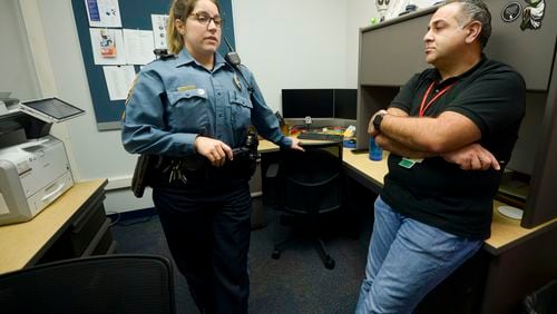 Gwinnett County Police officer Cpl. Tracey Reed (left) is seen with Pej Mahdavi, director of intensive outpatient services at View Point Health, in their office Thursday, Dec. 16, 2021 at the Gwinnett County Police Department . The duo is Gwinnett County’s only behavioral health unit and provides resources for people who interact with the police. (Daniel Varnado/ For the Atlanta Journal-Constitution)