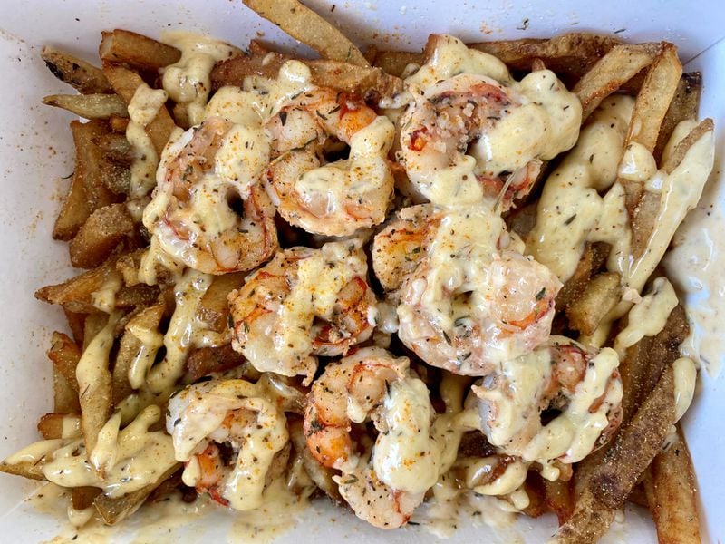 The Seafood Shawty from Puncho’s Late-Nite Fry Trap features wild-caught shrimp and crab, sautéed with fresh garlic and herbs, piled on hand-cut fries, and drizzled with Cajun aioli. This serving contains shrimp only. Wendell Brock for The Atlanta Journal-Constitution