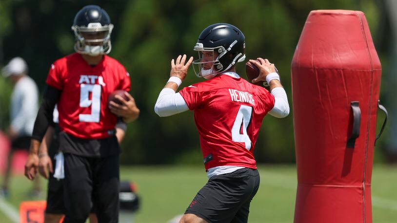 Atlanta Falcons quarterback Taylor Heinicke participates in a a drill in front of quarterback Desmond Ridder during OTAs at the Atlanta Falcons Training Camp, Wednesday, May 24, 2023, in Flowery Branch, Ga. Heinicke is a Collins Hill graduate. (Jason Getz / Jason.Getz@ajc.com)