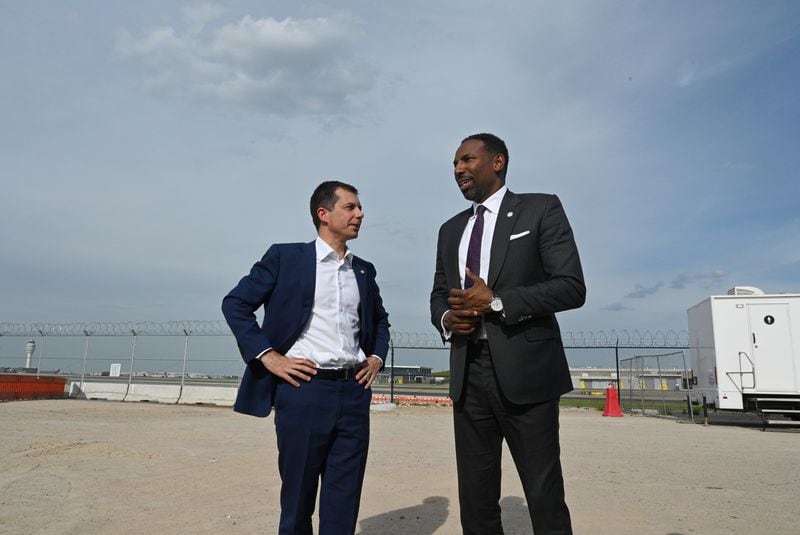 U.S. Transportation Secretary Pete Buttigieg (left) talks with Atlanta Mayor Andre Dickens at D Modular Unit Construction Yard near Hartsfield-Jackson Atlanta International Airport on Thursday, April 25, 2024. U.S. Transportation Secretary Pete Buttigieg joined local leaders Thursday at the world’s busiest airport to mark a milestone in one of the country’s major airport infrastructure initiatives. Buttigieg joined Atlanta Mayor Andre Dickens at the construction site where work is underway to build pieces of an expansion of Hartsfield-Jackson’s Concourse D. (Hyosub Shin / AJC)