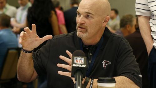 Falcons coach Dan Quinn talks with a reporter during the NFC head-coaches breakfast at the NFL annual meetings Wednesday, March 29, 2017, in Phoenix. (AP Photo/Ross D. Franklin)