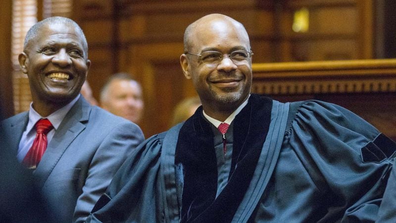 09/04/2018 — Atlanta, Georgia — Presiding Georgia Supreme Court Justice Harold D. Melton (center) laughs as retired Georgia Supreme Court Justice P. Harris Hines introduces him during the swearing in ceremony for the Georgia Supreme Court at the State Capitol in Atlanta, Thursday, August 30, 2018. Justice Melton was sworn in as the new Georgia Supreme Court Chief Justice. (ALYSSA POINTER/ALYSSA.POINTER@AJC.COM)