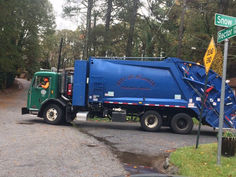 A city of Atlanta employee driving a city waste collection truck during his route. Photo by Bill Torpy