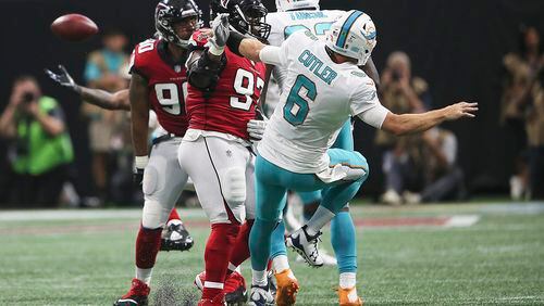Atlanta Falcons defensive tackle Grady Jarrett (97) hits Miami Dolphins quarterback Jay Cutler (6) drawing a penalty during the second half of an NFL football game, Sunday, Oct. 15, 2017, in Atlanta. Jarrett drew a foul on there play for roughing the passer. (AP Photo/John Bazemore)