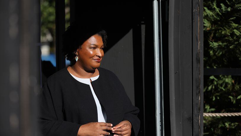 Georgia gubernatorial candidate Stacey Abrams listens as she is introduced to supporters at a restaurant in historic College Park during the “Let’s Get It Done” bus tour, Thursday, October 20, 2022, in College Park, Ga. (Jason Getz / Jason.Getz@ajc.com)