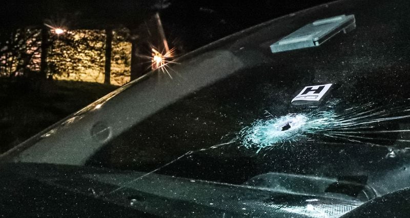 A car parked in front of the home had a bullet hole through the front windshield.