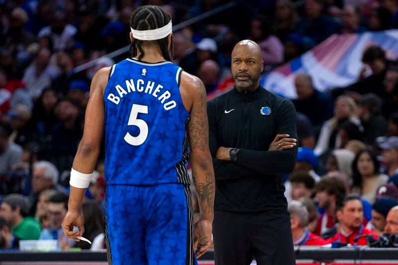 Orlando Magic head coach Jamahl Mosley, right, looks over at Paolo Banchero, left, during the first half of an NBA basketball game against the Philadelphia Phillies, Friday, April 12, 2024, in Philadelphia. The 76ers won 125-113. (AP Photo/Chris Szagola)