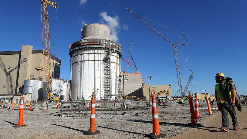 A construction worker walks by Plant Vogtle's Unit 4 on Tuesday, Dec 14, 2021, in Waynesboro, Georgia. “Curtis Compton / Curtis.Compton@ajc.com”`
