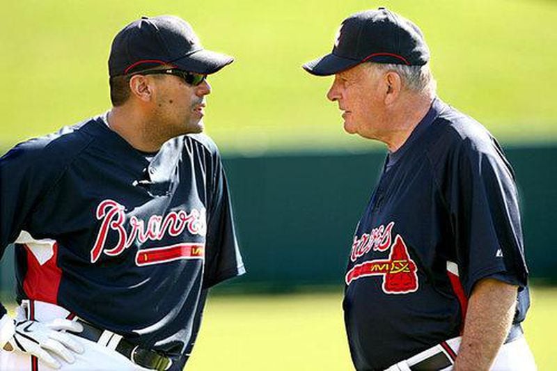  Eddie Perez (left) chats with legendary former Braves manager Bobby Cox during spring training near the end of Cox's career. (AJC file photo)