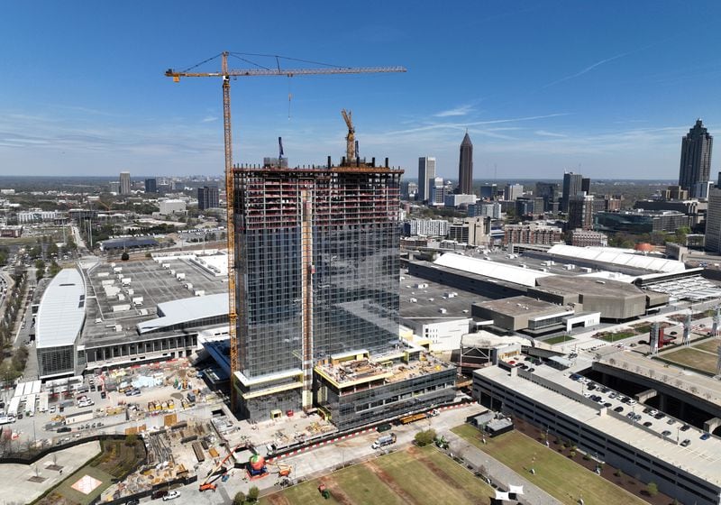 (**EMBARGO:  Do not use this photo until Tuesday morning, March 28, 2023** Hyosub) Aerial photograph shows construction site of Signia by Hilton Atlanta at Georgia World Congress Center, as construction crew prepare for topping out ceremony, Thursday, March 23, 2023, in Atlanta. Plans are in motion for GWCCA’s new headquarter hotel Signia by Hilton Atlanta. Featuring close to 1,000 rooms, this premier full-service hotel will sit on the northwest corner of the campus, adjacent to Building C of Georgia World Congress Center. (Hyosub Shin / Hyosub.Shin@ajc.com)