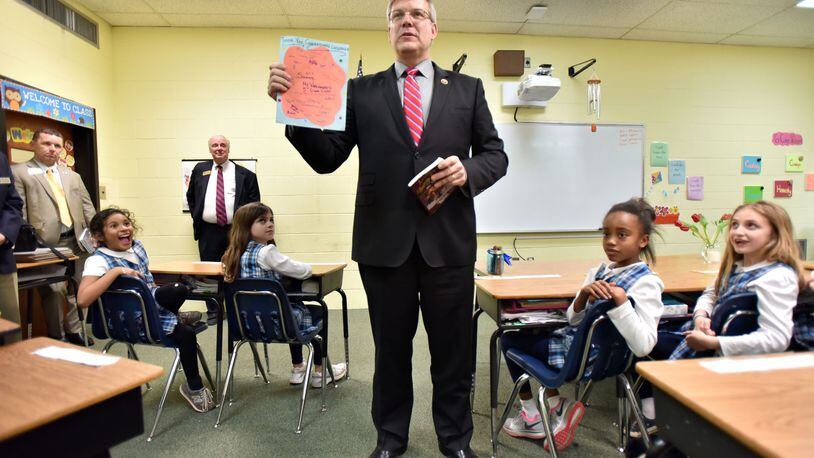 March 11, 2015 Atlanta - Freshman U.S. Rep. Barry Loudermilk (center) holds "Thank you" memos from students after he read "American History Stories" in 3rd grade classroom at Atlanta Classical Academy on Wednesday, March 11, 2015. Freshman Atlanta area U.S. Reps. Jody Hice and Barry Loudermilk campaigned on bringing a sharp new conservative voice to Washington. HYOSUB SHIN / HSHIN@AJC.COM Rep. Barry Loudermilk (AJC/Hyosub Shin)